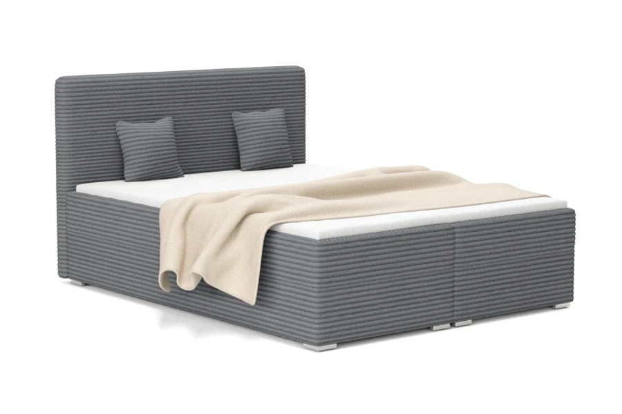 Dunkelgraues Polsterbett in Cord-Optik mit beiger Decke und Kissen.