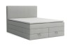 Hellgraues Boxspringbett mit weißem Topper auf weißem Hintergrund freigestellt.