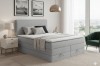 Graues Boxspringbett im modernen Schlafzimmer mit stilvoller Einrichtung und Dekoration.