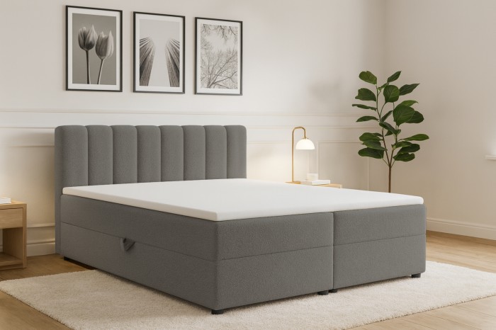 Modern eingerichtetes Schlafzimmer mit hellgrauem Boxspringbett, Wandbildern und Holzboden.