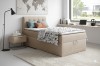 Modernes Schlafzimmer-Set mit beigem Boxspringbett und stilvoller Einrichtung.