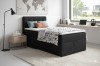 Schwarzes Boxspringbett im modern eingerichteten Schlafzimmer mit Teppich und Lampe.