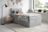 Modernes Schlafzimmer-Set mit grauem Boxspringbett und stilvoller Dekoration.