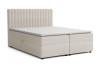 Beiges Boxspringbett mit gestepptem Kopfteil auf weißem Grund.