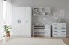 Weißes Kinderzimmer-Set mit Kleiderschrank, Schreibtisch und Kommode, blaue Griffe.