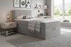 Gemütliches Schlafzimmer-Set mit grauem Boxspringbett, Nachttisch und moderner Inneneinrichtung.