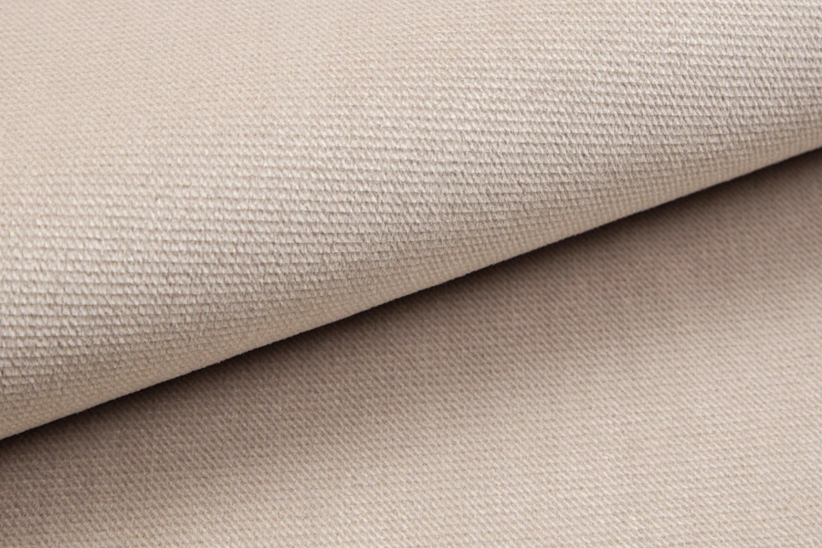 Detailaufnahme der beigen Stofftextur des Boxspringbettes.