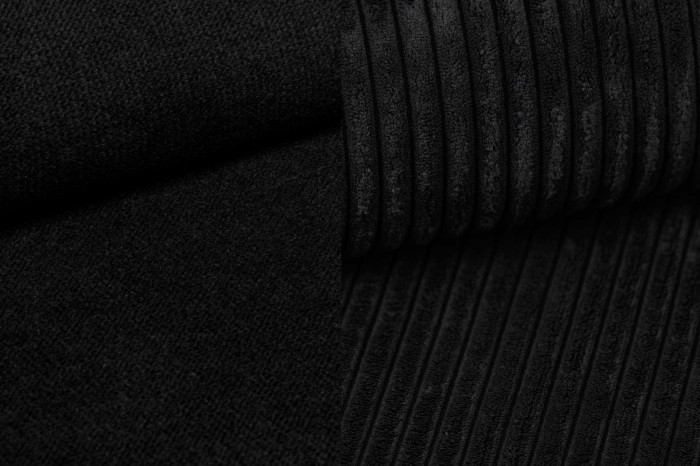 Textur-Detail von schwarzem Cord-Stoff für moderne Polstermöbel und Betten.