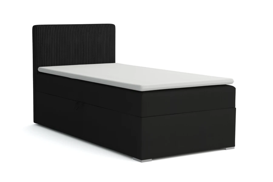 Modernes schwarzes Boxspringbett mit geriffeltem Kopfteil und weißem Topper für erholsamen Schlaf.