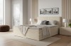 Boxspringbett in Creme für ein helles, modernes Schlafzimmer-Ambiente.