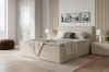 Boxspringbett in Sandfarben in gemütlicher, moderner Schlafzimmer-Einrichtung.