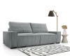 Modernes graues Cordsofa im Wohnzimmer mit Stehlampe und Teppich.