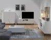Komplettes Wohnzimmer-Set in elegantem Weiß mit modernen, geriffelten Fronten und schwarzem Gestell.