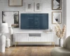 Modernes TV-Board in Weiß vor einer weißen Backsteinwand in einem stilvoll eingerichteten Wohnzimmer.