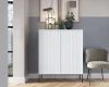 Stilvolles Wohnzimmer-Set mit weißem Riffelschrank, modernem Sessel und Dekoration.