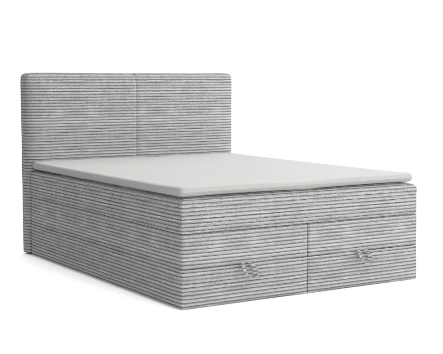 Hellgraues Boxspringbett mit Cord-Struktur und zwei geräumigen Schubladen am Fußende.