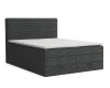 Graues Boxspringbett aus Cord-Stoff mit integrierten Schubladen für Stauraum.