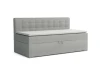 Graues Boxspring-Einzelbett mit gestepptem Kopfteil und weißem Topper.