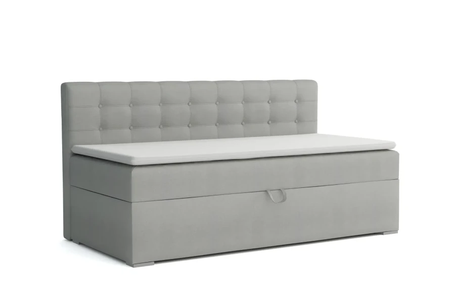 Graues Boxspring-Einzelbett mit gestepptem Kopfteil und weißem Topper.