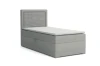 Graues Einzel-Boxspringbett mit geriffeltem Kopfteil und Bettkasten vor weißem Hintergrund.