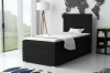 Schwarzes Boxspringbett JAX als Einzelbett in einem hellen, modern eingerichteten Schlafzimmer-Ambiente.
