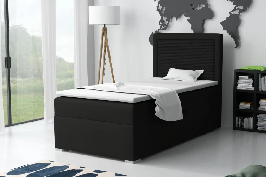 Schwarzes Boxspringbett JAX als Einzelbett in einem hellen, modern eingerichteten Schlafzimmer-Ambiente.