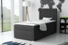 Graues Boxspringbett JAX im stilvollen Schlafzimmer mit Weltkarte-Wanddeko, Stehlampe und großen Fenstern.