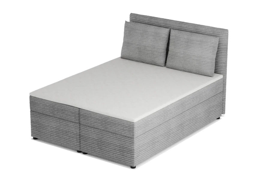 Perspektivische Ansicht eines grauen Boxspringbetts mit weichem Breitcord-Bezug.