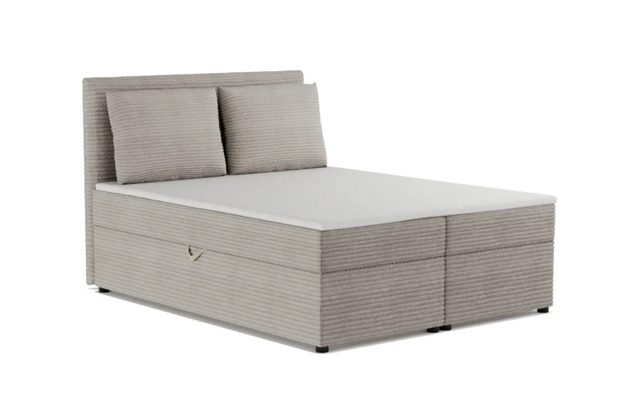 Beiges Boxspringbett mit Cord-Bezug und zwei passenden Kissen.