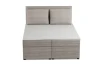 Vorderansicht eines beigen Boxspringbetts mit Kopfteil aus Cord.