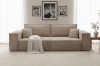 Stilvolles taupefarbenes Cord-Sofa in einem hellen Wohnzimmer-Ambiente mit Wandbildern