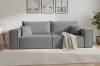 Stilvolles graues Sofa im Wohnzimmer mit Teppich und Wandbildern.