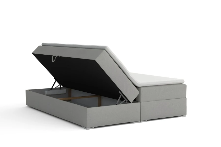 Boxspringbett in Grau mit offenem Bettkasten für zusätzlichen Stauraum im Schlafzimmer.