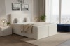Modern beige boxspringbed in corduroy-look voor een groot raam.