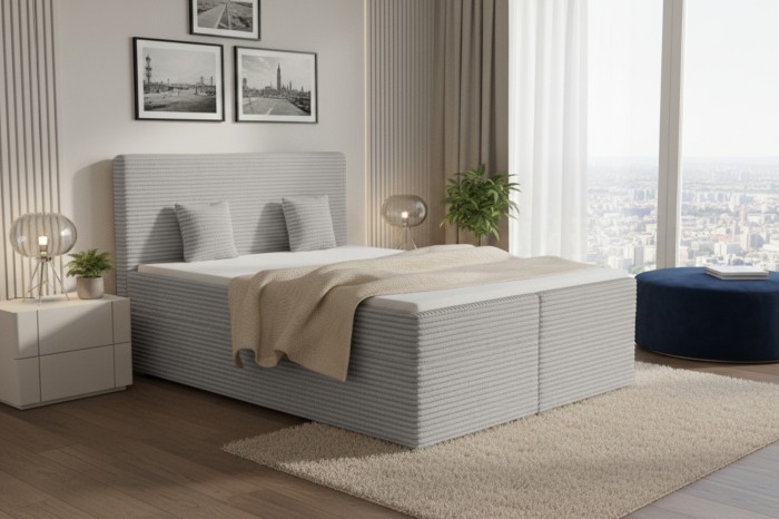 Hellgraues Boxspringbett mit Cord-Struktur in einem modern eingerichteten Schlafzimmer.