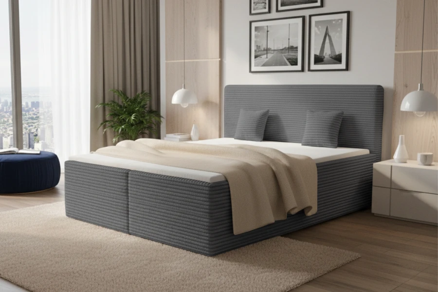 Elegantes Boxspringbett in Dunkelgrau mit Cord-Optik und Kissen in modernem Schlafzimmer.