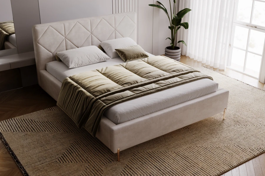 Cosy beige upholstered bed in a modern bedroom from a side perspective.