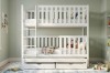 Modern white bunk bed with third pull-out bed and storage space in the children's room.