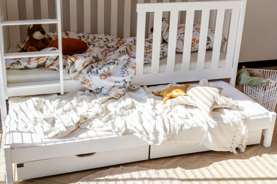 White children's bunk bed with ladder and practical pull-out bed for overnight guests.