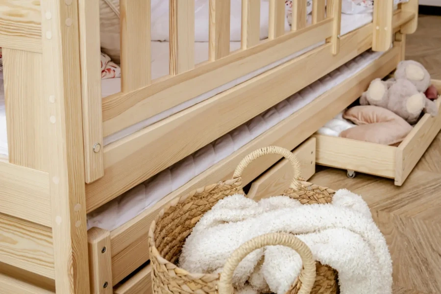 Functional children's bed made of pine wood with trundle bed and practical drawers.