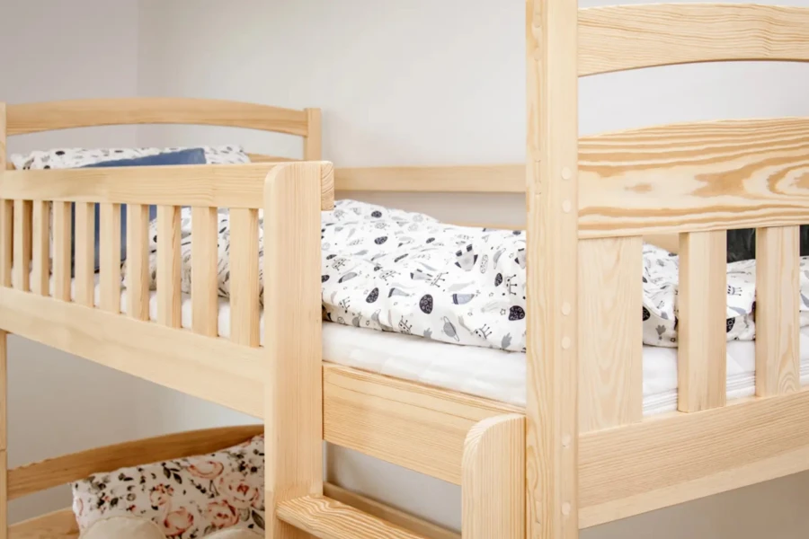 Upper level of a solid wood bunk bed with safety rail for children.