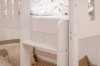 Close-up of the ladder and fall protection of a white children's bunk bed.