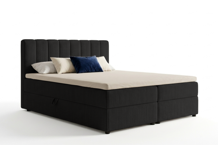Modernes schwarzes Boxspringbett mit Cord-Bezug und Bettkasten auf weißem Grund.