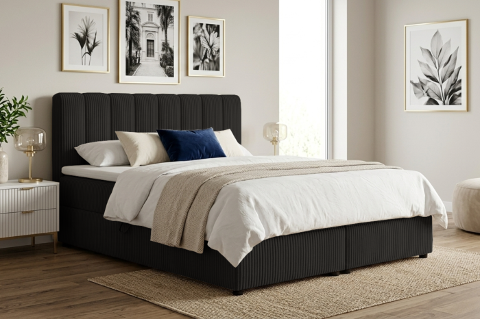 Schwarzes Boxspringbett mit Cord-Struktur in einem stilvollen Schlafzimmer.