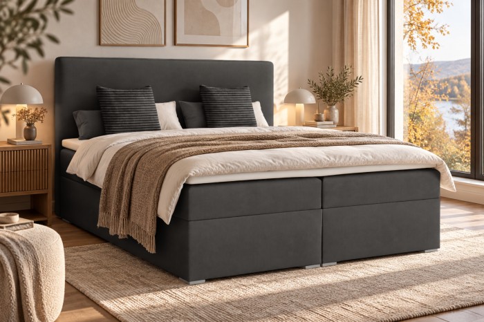 Dunkelgraues Boxspringbett im herbstlich eingerichteten Schlafzimmer.