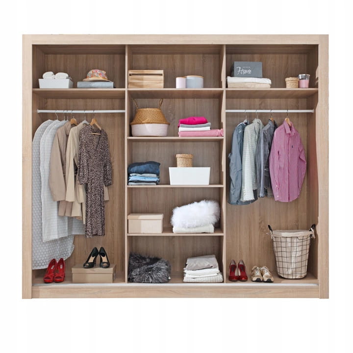 Interior view of a wardrobe with organised layout, shelves and clothes rails.